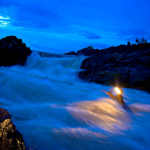 A fisherman crosses the Li Phi Falls by rope during the early monsoon season in July.