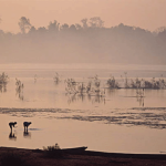 Lao people bathing in the early morning in the Mekong River in Southern Laos.
