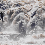 A daring fisherman crosses the Khon Phapheng falls on a wire that he and his friend built to access fishing areas during the rainy season.